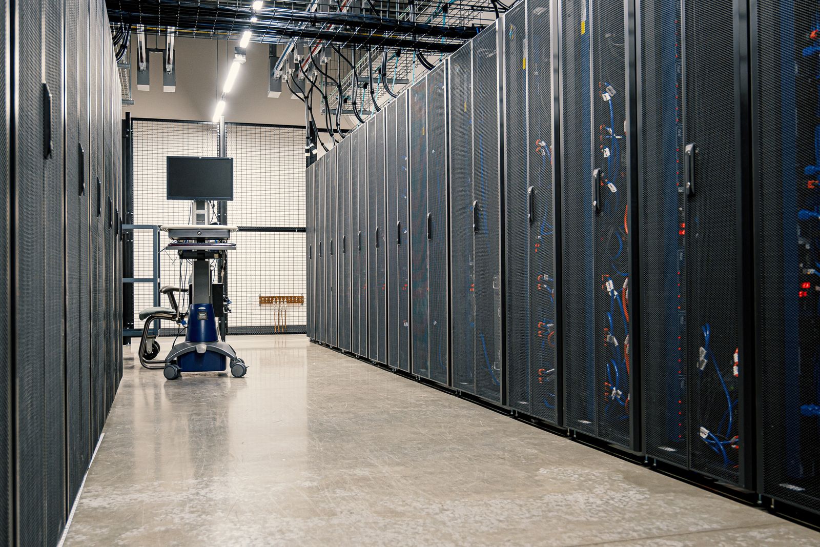 Data centre aisle lined with server racks
